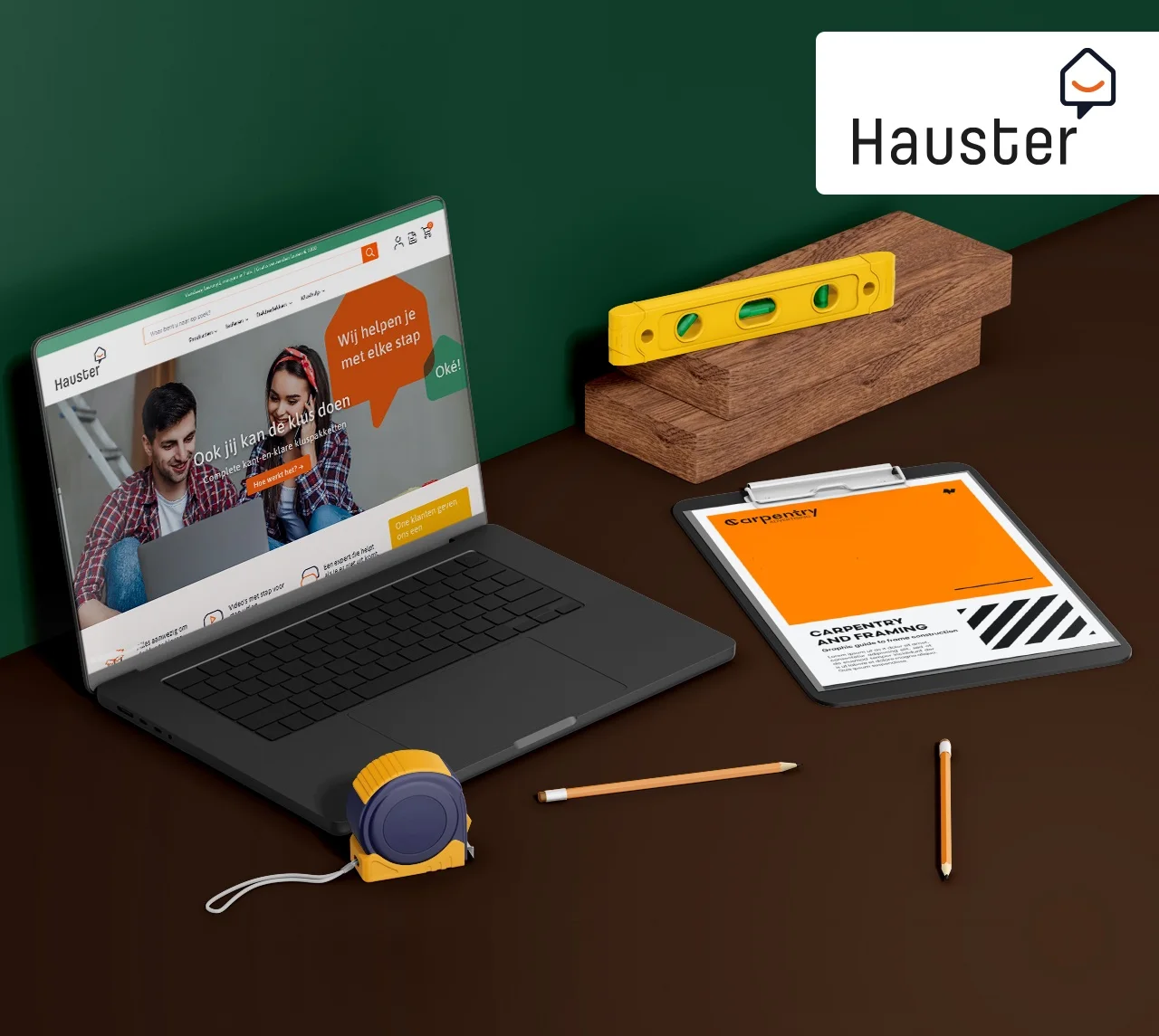 Hauster eCommerce design shown on a laptop beside DIY tools and construction materials
